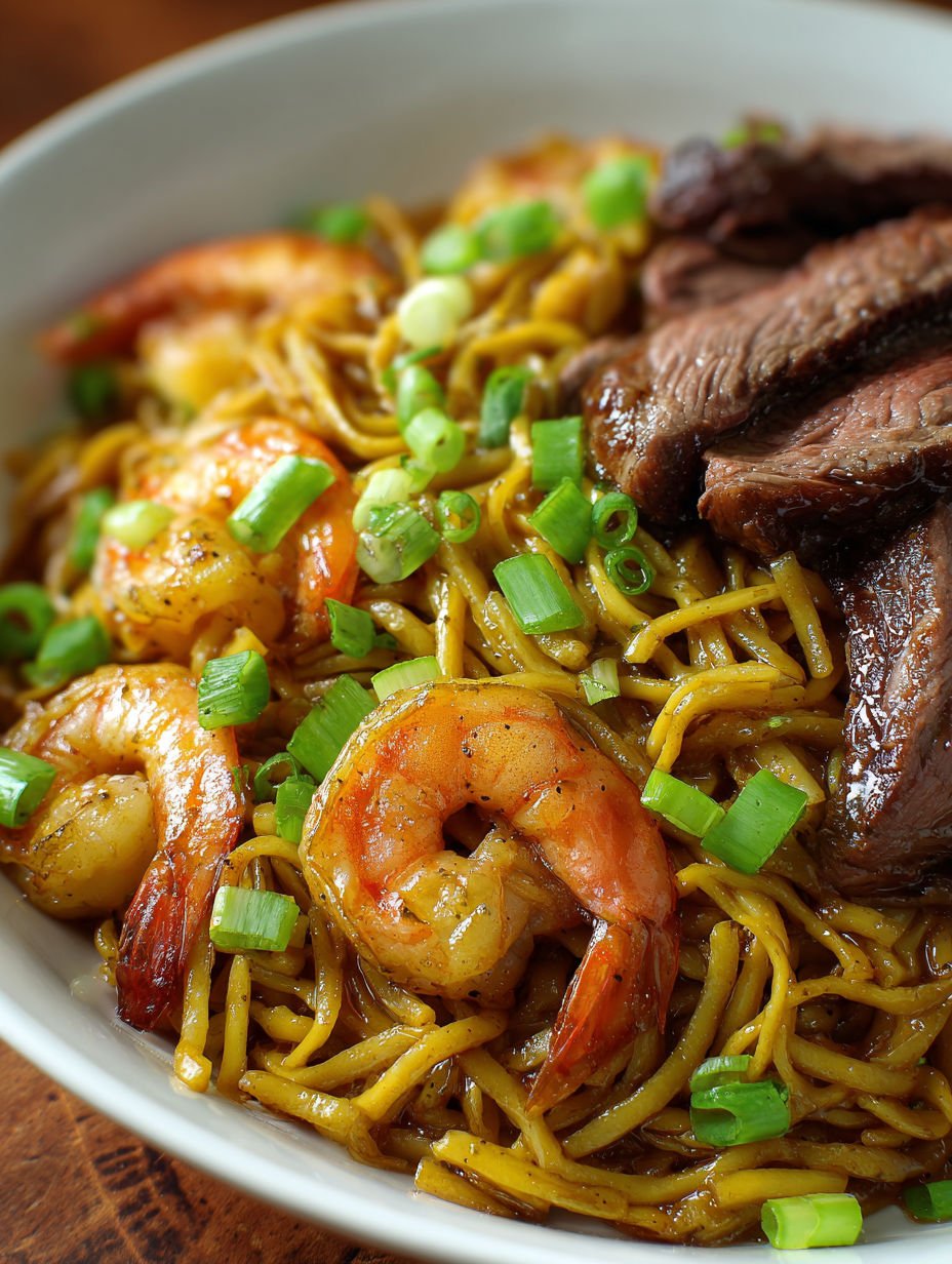 A bowl of shrimp and beef teriyaki noodles.