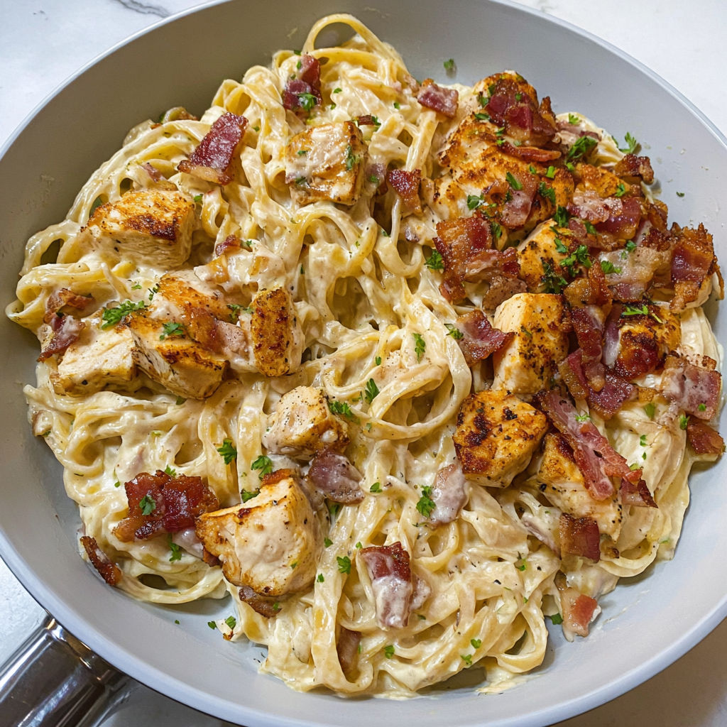 A bowl of pasta with chicken and bacon.
