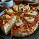 A slice of cake with onions on top.