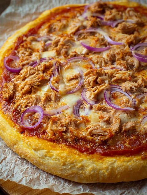 A pizza with tuna and onions.